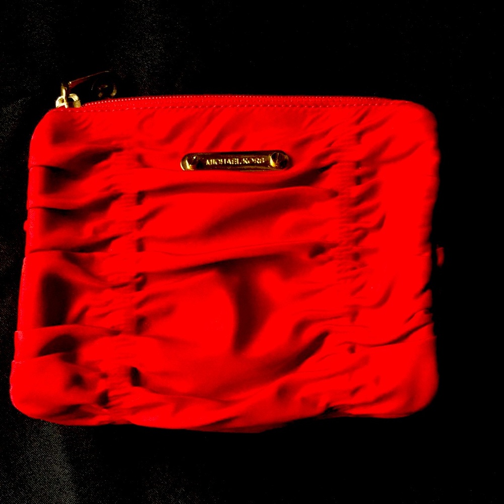 A small fabric evening clutch or cute makeup bag.